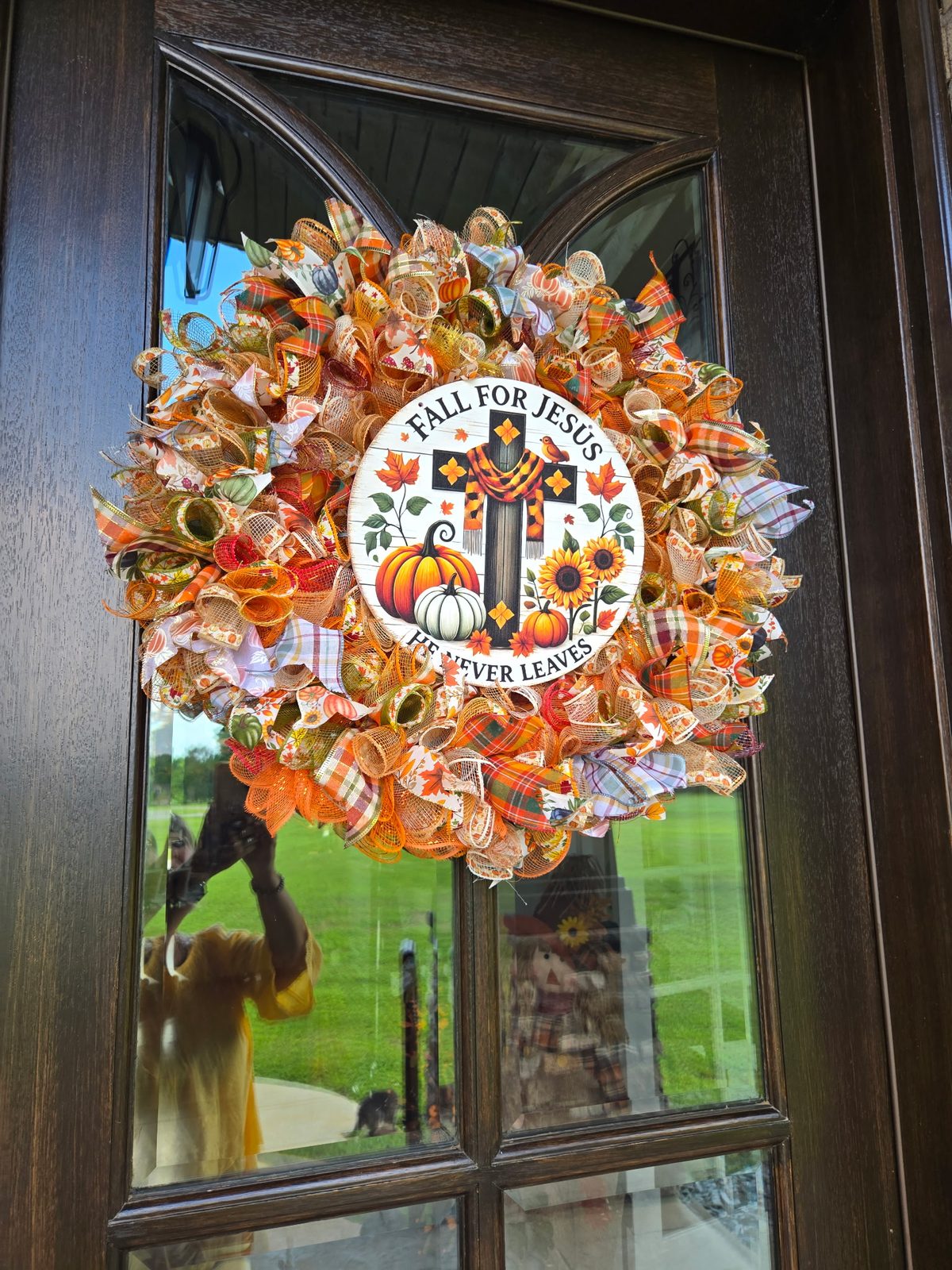 Fall wreath hanging on a glass front door