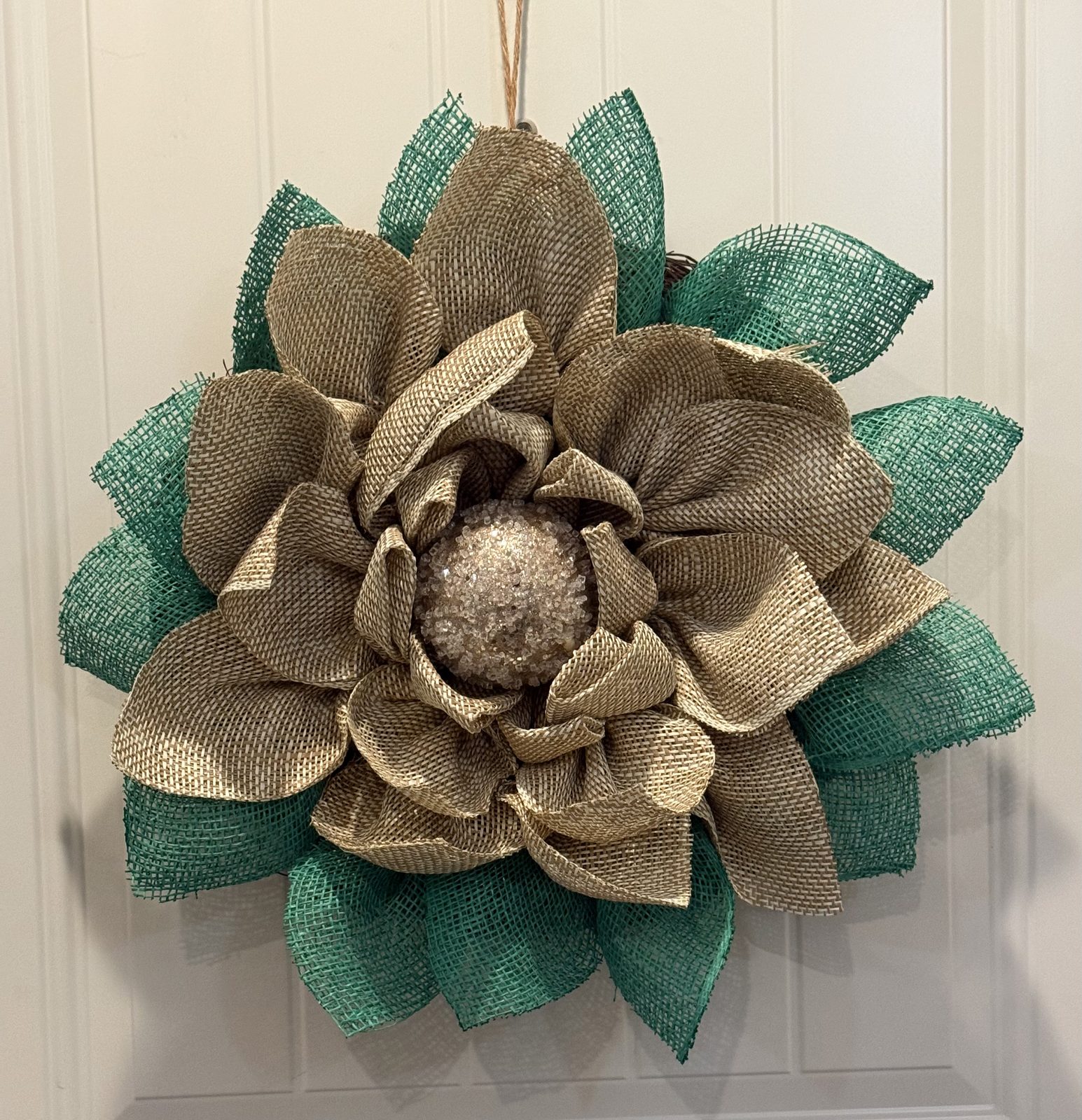 Burlap flower wreath with green leaves