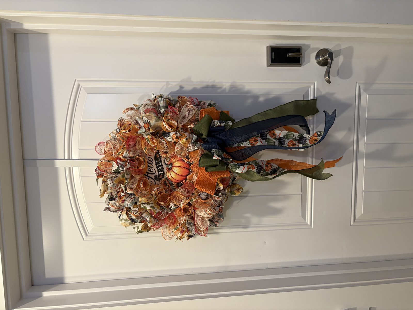 Small pumpkin wreath on a white door