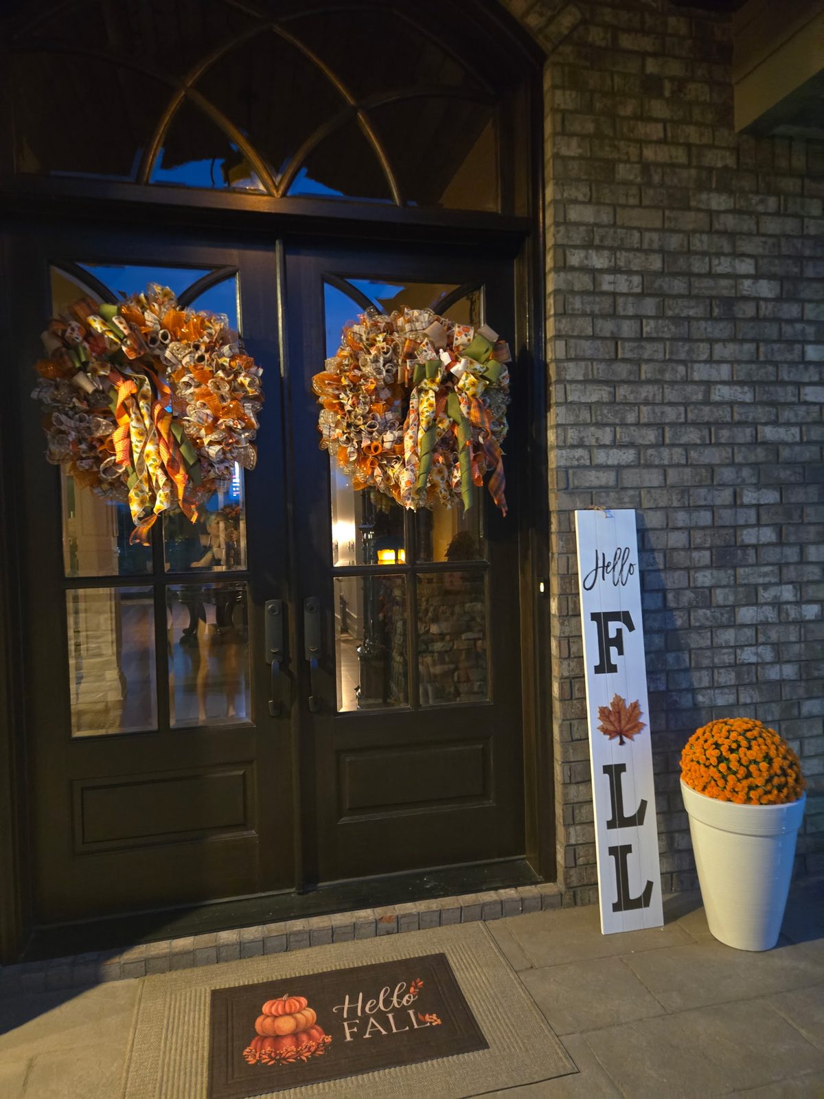 Handmade fall wreaths hanging on a front door
